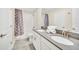 Bathroom with shower/tub combo, double vanity, and grey tile at 730 Drop Shot Dr, Davenport, FL 33896