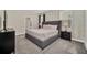 Spacious bedroom with a large bed, nightstands, and stylish decor at 730 Drop Shot Dr, Davenport, FL 33896