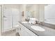 Clean bathroom with double vanity, shower, and toilet at 730 Drop Shot Dr, Davenport, FL 33896