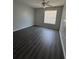 Spacious bedroom with grey vinyl flooring and window at 1081 S Hiawassee Rd # 717, Orlando, FL 32835