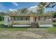 Mobile home with a large screened porch and mature trees at 350 S 5Th St, Orlando, FL 32833