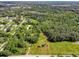 Aerial view of a wooded lot with a cleared area near a residential area at 350 S 5Th St, Orlando, FL 32833