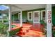 Charming home with a spacious green front porch and orange steps at 350 S 5Th St, Orlando, FL 32833