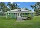 Charming green house with a metal roof and large yard at 350 S 5Th St, Orlando, FL 32833