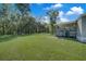 Spacious backyard with grassy area, wooden fence, and playset at 350 S 5Th St, Orlando, FL 32833