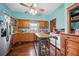 Country kitchen with wooden cabinets, island, and stainless steel appliances at 350 S 5Th St, Orlando, FL 32833