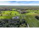 Aerial view of expansive property with lush pastures and several ponds at 350 S 5Th St, Orlando, FL 32833