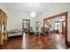 Open living room with hardwood floors, showing access to kitchen and stairs at 350 S 5Th St, Orlando, FL 32833
