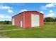 Spacious red metal building with a large roll-up door at 350 S 5Th St, Orlando, FL 32833