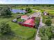 Aerial view of a property with multiple buildings, a pond, and lush green landscape at 350 S 5Th St, Orlando, FL 32833