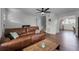 Spacious living room with leather sectional and hardwood floors at 2935 Aein Rd, Orlando, FL 32817