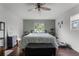Main bedroom with ceiling fan, large bed, and window view at 2935 Aein Rd, Orlando, FL 32817