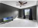 Bedroom with dark-painted walls, ceiling fan, and window at 2935 Aein Rd, Orlando, FL 32817