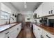 Modern kitchen with white cabinets and wood countertops at 2935 Aein Rd, Orlando, FL 32817