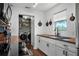 Modern kitchen with white cabinets, wood countertops, and laundry in unit at 2935 Aein Rd, Orlando, FL 32817