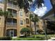 Exterior of a three-story condo building with balconies and landscaping at 2484 San Tecla # 303, Orlando, FL 32835