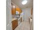 Kitchen with light oak cabinets, white appliances, and tile flooring at 2484 San Tecla # 303, Orlando, FL 32835