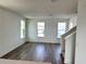 Bright living room with hardwood floors and multiple windows at 15124 Grove Lake Dr, Winter Garden, FL 34787