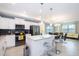 Modern kitchen with white cabinetry, stainless steel appliances, and breakfast bar at 4721 Clock Tower Dr # 207, Kissimmee, FL 34746