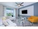 Living room with comfy seating, large TV, and access to balcony at 4721 Clock Tower Dr # 207, Kissimmee, FL 34746