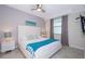 Main bedroom with a king bed, nightstands and ceiling fan at 4721 Clock Tower Dr # 207, Kissimmee, FL 34746
