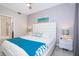 Main bedroom with a large bed, nightstands, and ceiling fan at 4721 Clock Tower Dr # 207, Kissimmee, FL 34746