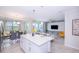Open concept kitchen with island, dining area, and living room view at 4721 Clock Tower Dr # 207, Kissimmee, FL 34746