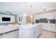Modern white kitchen with center island and stainless steel appliances at 4721 Clock Tower Dr # 207, Kissimmee, FL 34746
