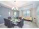 Bright dining area with glass table, seating, and adjacent sitting area at 4721 Clock Tower Dr # 207, Kissimmee, FL 34746
