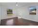 Bright bedroom with dark brown flooring and two windows at 1213 Baranova Rd, Ocoee, FL 34761