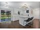 Bright kitchen features white cabinets, quartz countertops, and island with seating at 1213 Baranova Rd, Ocoee, FL 34761
