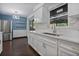 Modern kitchen with white cabinets, stainless steel sink, and quartz countertops at 1213 Baranova Rd, Ocoee, FL 34761
