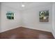 Well-lit bedroom with wood floors and two windows at 1213 Baranova Rd, Ocoee, FL 34761