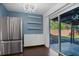 Eat-in kitchen with stainless steel refrigerator and backyard access at 1213 Baranova Rd, Ocoee, FL 34761