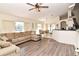 Open living room with a sectional sofa, view into kitchen and dining area at 985 Feather Dr, Deltona, FL 32725