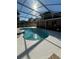 Inviting kidney-shaped pool with a screened enclosure at 1833 Queen Palm Dr, Apopka, FL 32712