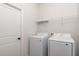 Laundry room with washer, dryer, and overhead shelving at 22 Dogwood Drive Loop, Ocala, FL 34472