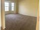 Living room with neutral carpet and bay windows at 2688 Hawthorne Ln, Kissimmee, FL 34743