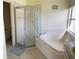 Bathroom features corner bathtub and shower stall at 2688 Hawthorne Ln, Kissimmee, FL 34743