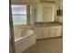 Primary bathroom with double sinks and corner tub at 2688 Hawthorne Ln, Kissimmee, FL 34743