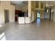 Large living room with tile floors and a view into the kitchen at 2688 Hawthorne Ln, Kissimmee, FL 34743