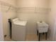 Laundry room with washer, dryer hookups, and utility sink at 2688 Hawthorne Ln, Kissimmee, FL 34743