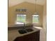 Kitchen with a double sink and view to a backyard patio at 2688 Hawthorne Ln, Kissimmee, FL 34743