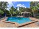 Community pool with a covered patio area and lounge chairs at 4249 E Weeping Willow Cir, Winter Springs, FL 32708