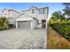 Two-story house with gray siding and a paver driveway at 7387 Marker Ave, Kissimmee, FL 34747