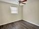 Bright bedroom with wood-look flooring and ceiling fan at 1904 Historic Goldsboro Blvd, Sanford, FL 32771