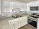 Modern kitchen with white cabinets and granite countertops at 1904 Historic Goldsboro Blvd, Sanford, FL 32771