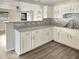 Updated kitchen with white cabinets and stylish backsplash at 1904 Historic Goldsboro Blvd, Sanford, FL 32771