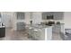 Modern kitchen with gray cabinets, granite counters, and island at 2630 Sage Valley Way, Winter Haven, FL 33884
