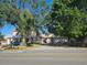 Two story home with large yard, driveway, and mature trees at 4715 Beach Blvd, Orlando, FL 32803